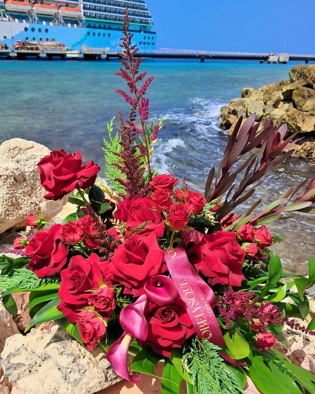 Red roses and calla lilies on the rocks by the cruise terminal
